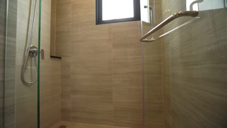 Simple-White-Shower-Head-in-Bathroom-with-Granite-Tile-Wall