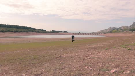 person running near a small lake