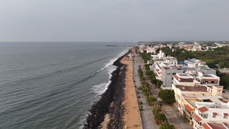 panoramic drone footage showcasing pondicherry’s french-style architecture near the beach
