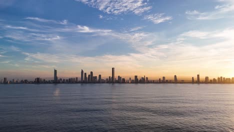 aerial timelapse capturing the sunrise over gold coast's skyline, highlighting vibrant colors and serene ocean views