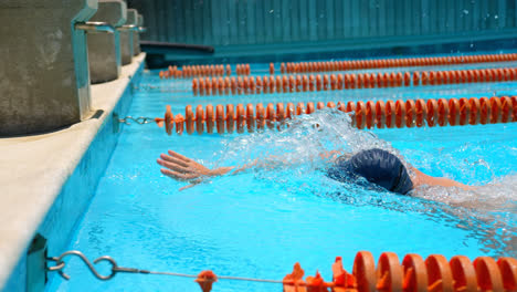 male swimmer swimming inside pool 4k