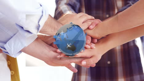 animation of airplanes flying around rotating globe over diverse coworkers stacking hands in office