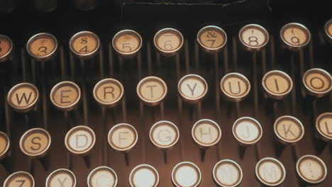 abstract dolly shot across antique typewriter keys - isolated type keys