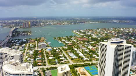 Aerial-drone-shot-slowly-descending-over-the-Ritz-Carlton-and-other-residential-buildings-on-Singer-Island-in-West-Palm-Beach-Florida-looking-toward-the-intercoastal-waterway