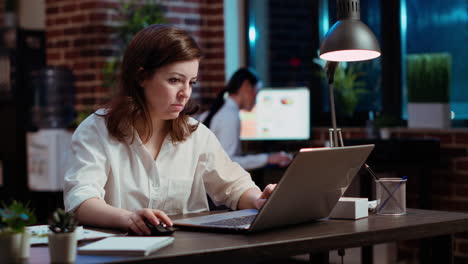 businesswoman creating marketing project plan on laptop