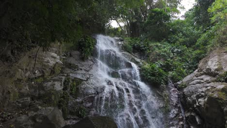 Water-cascades-down-steep-rocky-outcrop-in-forested-jungle-of-Minca-Colombia