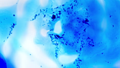 Ink mixing in blue liquid, abstract shot focusing on vibrant swirls and textures