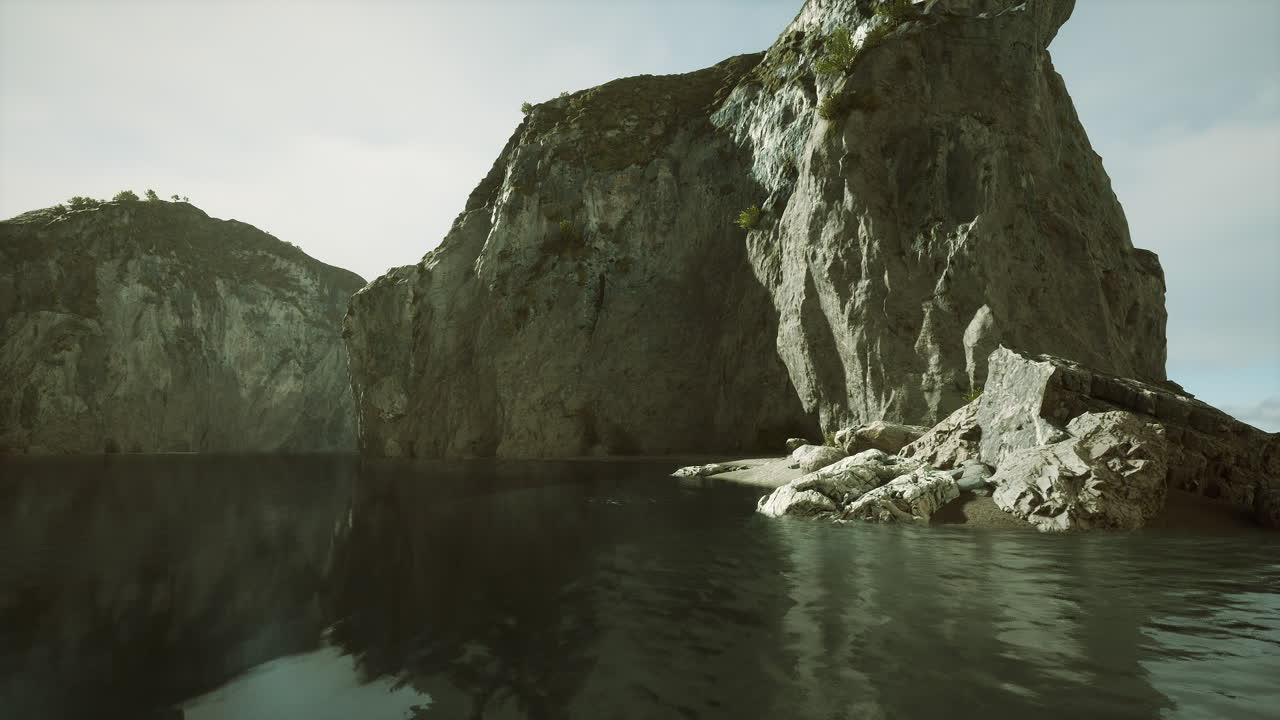 Towering coastal cliffs overlooking calm waters at sunset