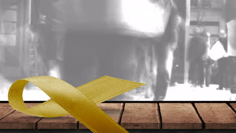 animation of yellow ribbon on wooden surface with grey cloud