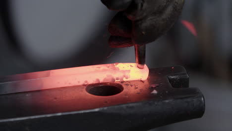 Blacksmith-Hammering-A-Hole-In-Red-Hot-Metal