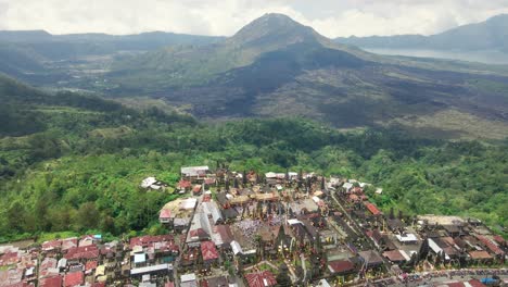 Drone-shot-of-religious-Hindu-temple-Tuluk-Biyu-with-volcano-Batur-at-the-background-located-in-Kintamani-region