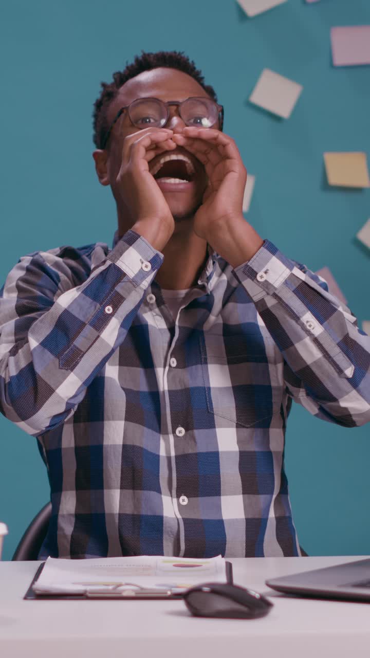 Excited man shouting in office