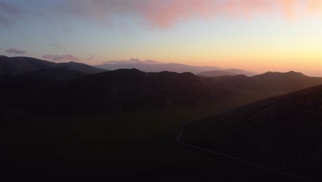 Aerial-view-of-a-beautiful-national-park-as-the-sun-rises-over-faraway-mountains