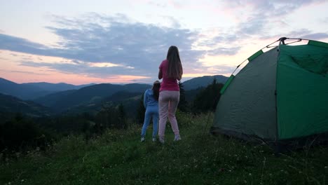 two girls girlfriends are resting in the alps they are having fun two girls girlfriends are resting in the alps they are having fun hiking in the mountains