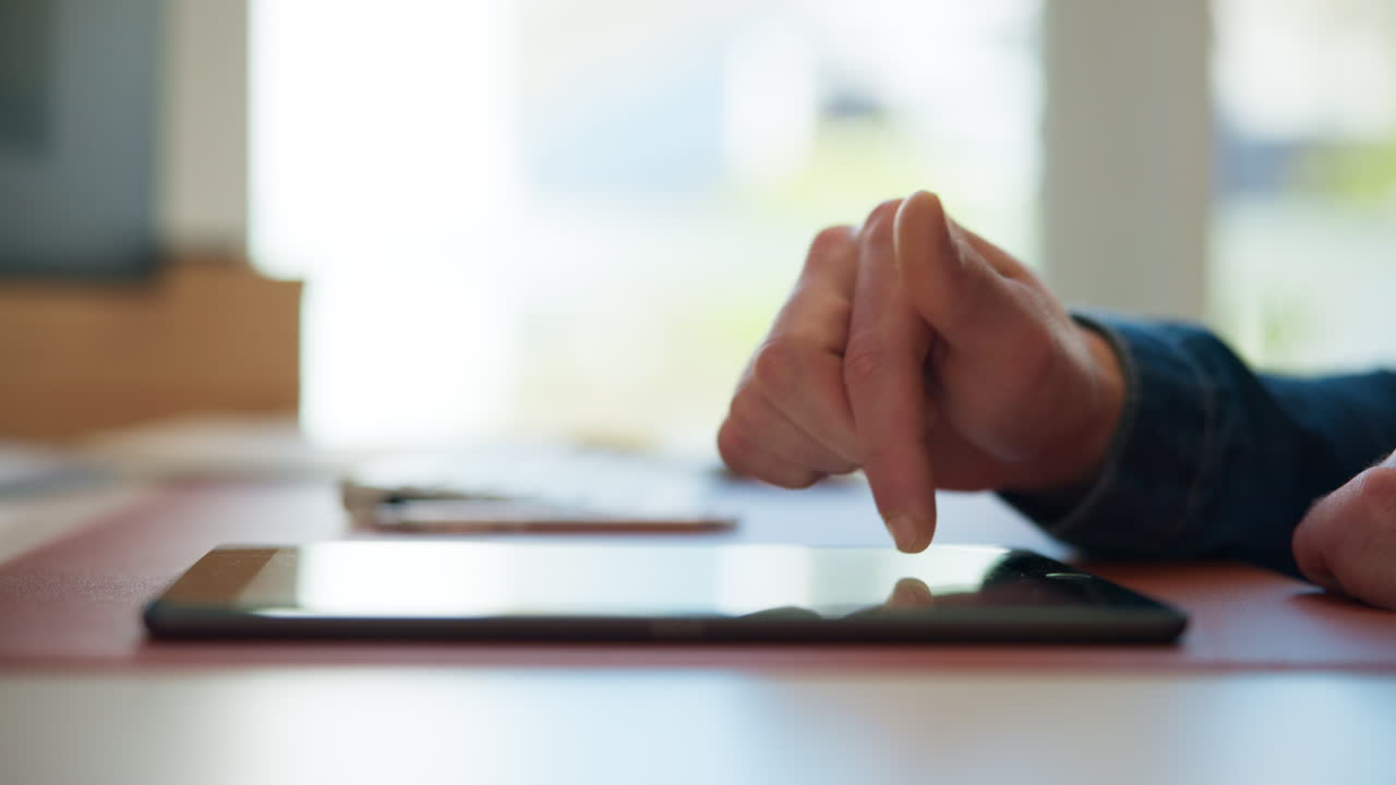 Close-Up of Hand Tapping and Scrolling on a Digital Tablet