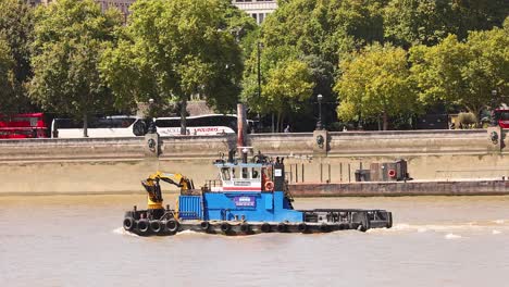 blue support vessel moving along the river