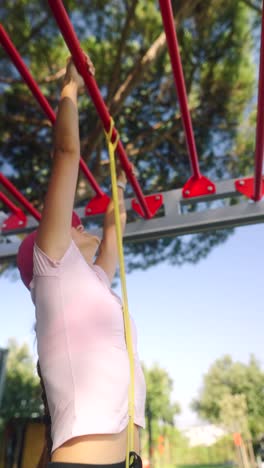 woman doing resistance band pull-ups outdoors