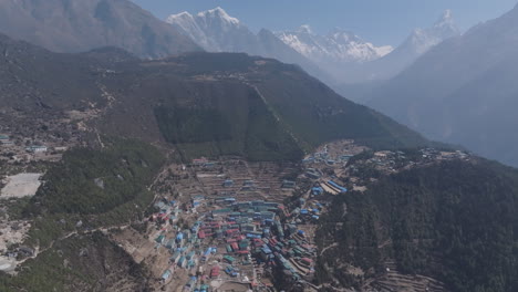 aerial view of namche bazaar village enroute to everest base camp with lush hills, shiny mountain range, and scenic community landscape