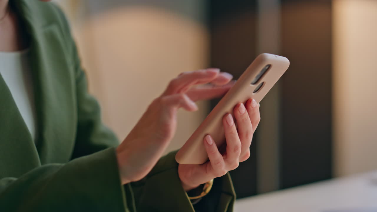 Businesswoman hands using smartphone in office closeup. Woman watching pictures