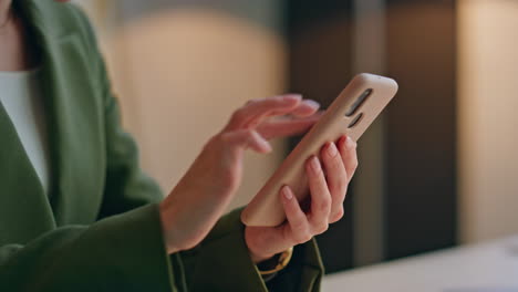 businesswoman hands using smartphone in office closeup. woman watching pictures
