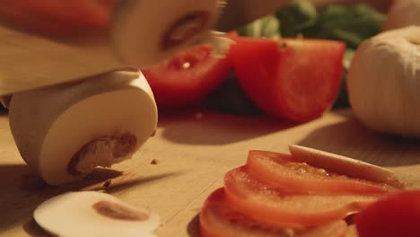 Close-up-of-chefs-knife-cutting-mushroom-in-thin-slices