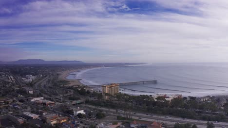 wide descending aerial shot of downtown ventura, california along the coast