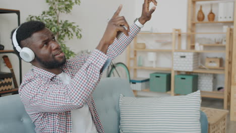 man dancing and singing to music at home