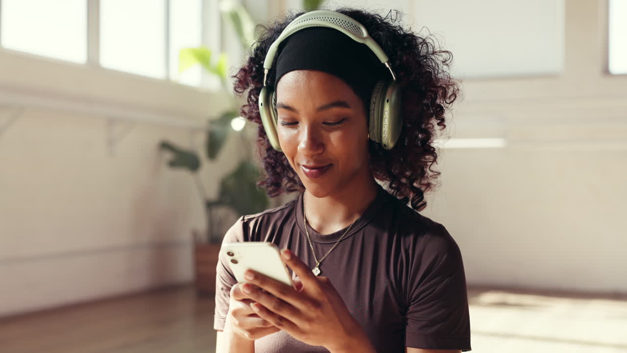 Woman listening to music on her phone with headphones