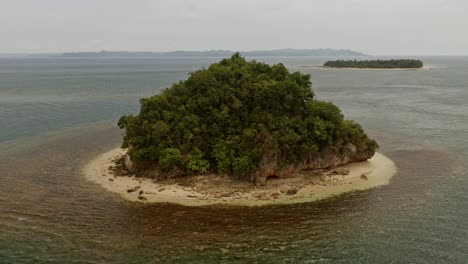 aerial orbital view around malingin island with scenic background views of the philippines