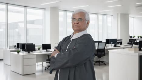 portrait of indian senior lawyer standing crossed hands