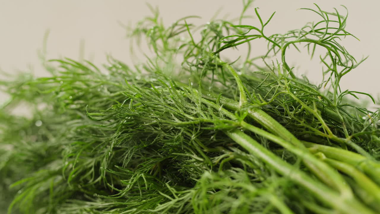 Cutting dill, chef cut dill with knife on a wooden board, close up at home, vitamin vegan greens.