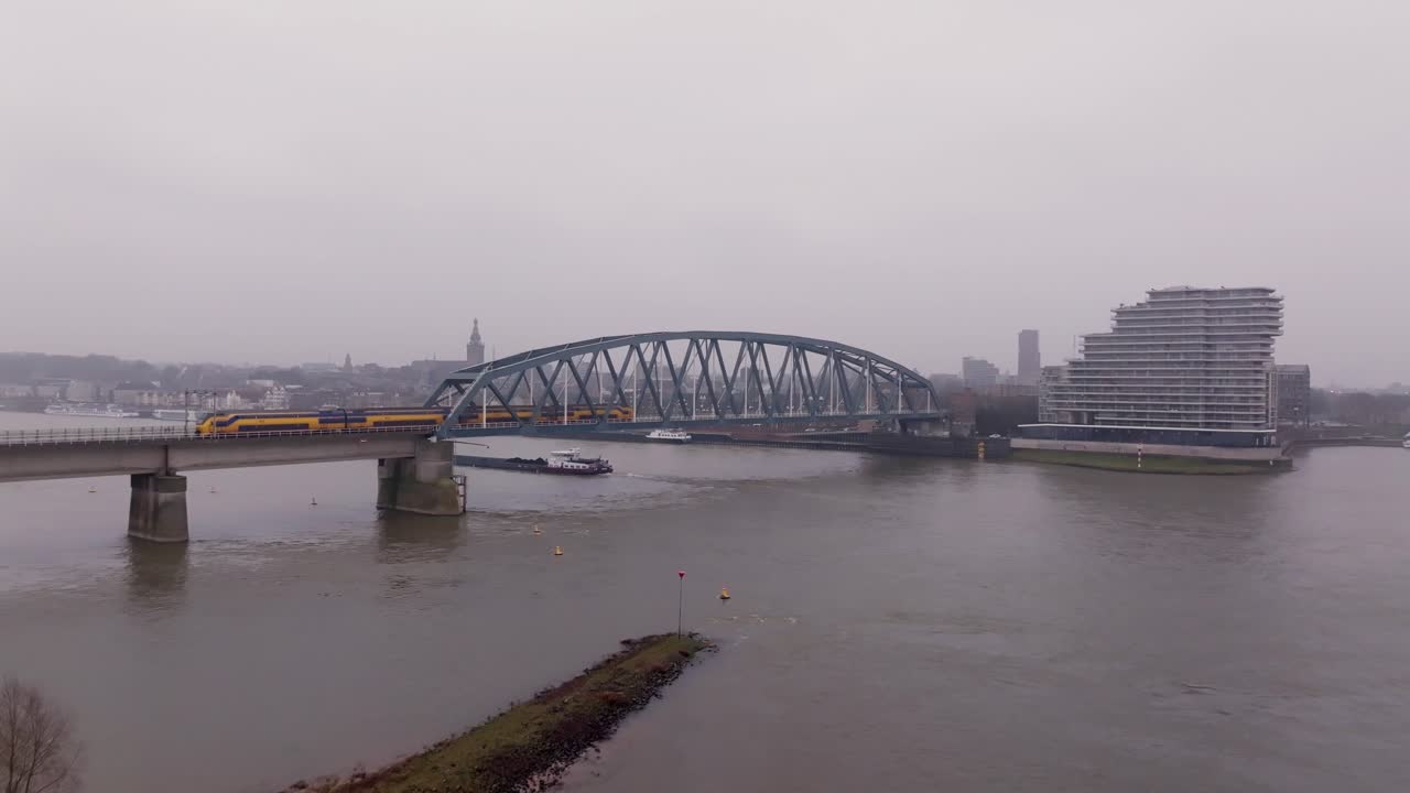 Scenic Drone Shot on River Waal with the city of Nijmegen in the Background