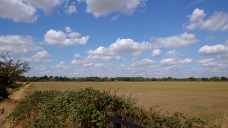 wide shot of british countryside with blue skies and light cloud