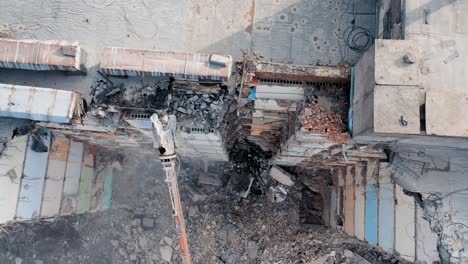clearing damage on a construction site using special equipment for a tractor. demolition of a multi-storey building. construction garbage