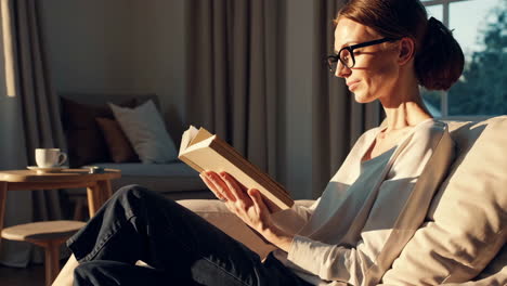 woman reading a book in a cozy living room