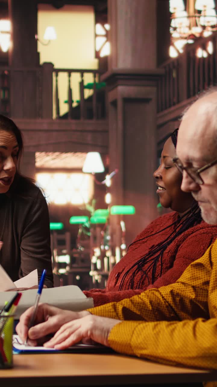 Vertical Video Mature performers engaged in drama rehearsal at the library