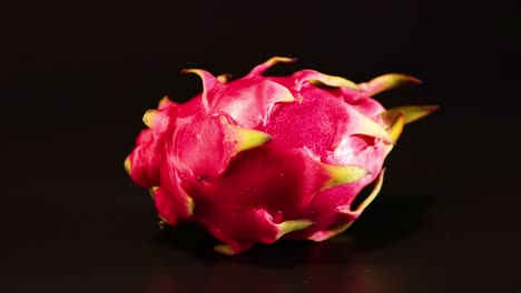 dragon fruit rotates smoothly against a dark backdrop