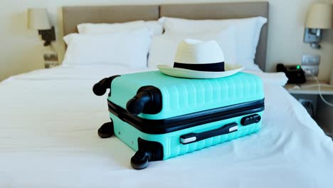 a suitcase and hat inside a beautiful hotel room
