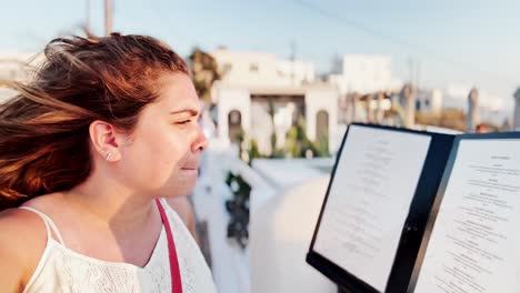 woman enjoying santorini breeze, summer vacation selfie