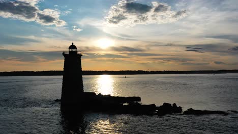 Portsmouth,-NH-lighthouse-Aerial-Pass-by-shadowed-sunset-sea