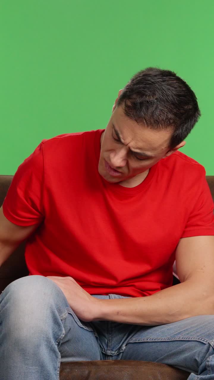 Sad man waiting for a message on green screen background