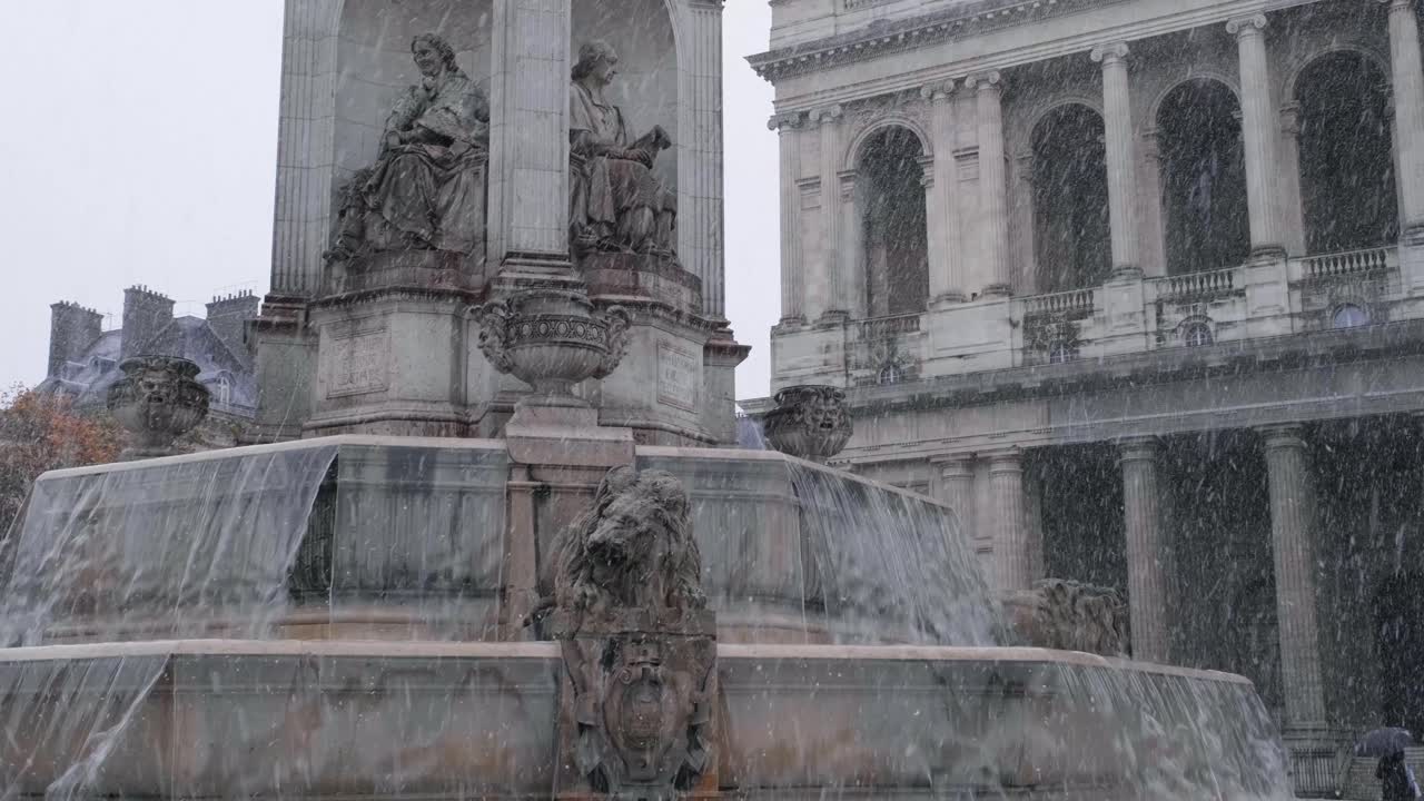 Snow falling in Paris in front of the Saint-Sulpice's fountain