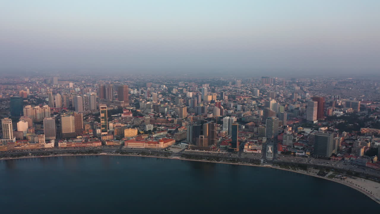 Traveling front, Luanda city, golden hour flying over Luanda bay, Africa