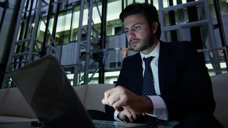 arabic male business traveller laptop night hotel atrium