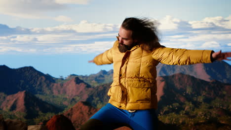 adventure seeker stands at the peak with the satisfaction of a successful climb