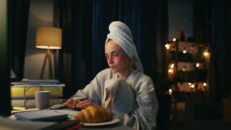 focused woman typing computer closeup. serious bathrobe lady browsing internet