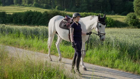 a-woman-is-walking-a-white-horse