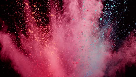 super slow motion of colored powder explosion isolated on dark background.