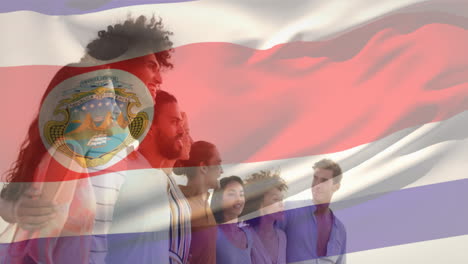 animación de la bandera de costa rica ondeando sobre diversos amigos formando una cadena humana al mirar el mar
