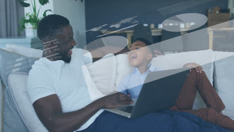 animation of statistical data processing over african american father and son using laptop at home